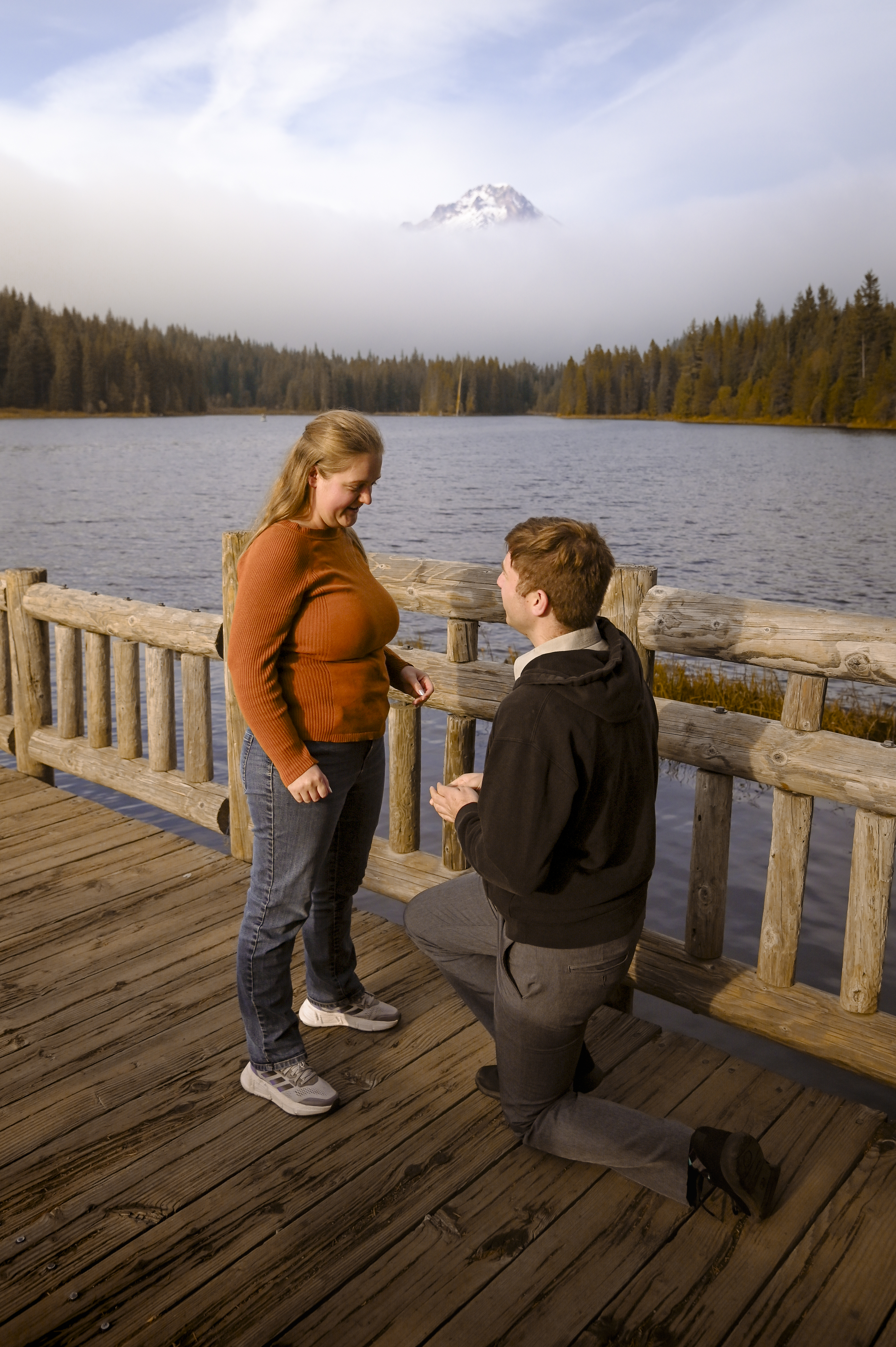 Caleb kneeling to propose to Haley at Trillium Lake.